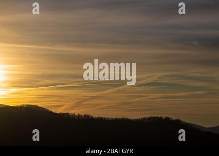 Contrails and clouds make interesting designs in the sky at the Tanbark Ridge Overlook on the Blue Ridge Parkway in Asheville, NC, USA. Stock Photo