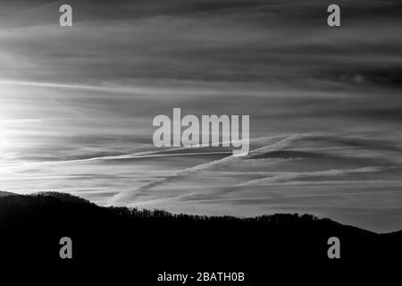 Contrails and clouds make interesting designs in the sky at the Tanbark Ridge Overlook on the Blue Ridge Parkway in Asheville, NC, USA. Stock Photo