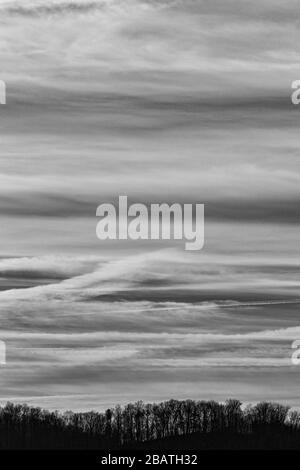 Contrails and clouds make interesting designs in the sky at the Tanbark Ridge Overlook on the Blue Ridge Parkway in Asheville, NC, USA. Stock Photo