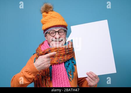 Smiling senior man pointing finger on copyspace Stock Photo