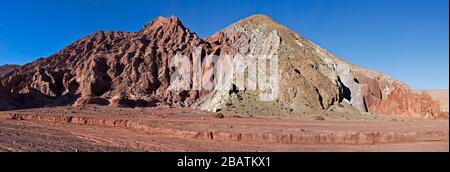 Panorama of the many colors of igneous rock in Rainbow Valley (red, orange, brown, green, white), Atacama Desert, Chile Stock Photo