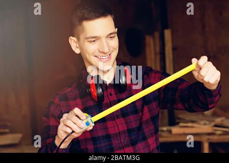 Workman at the sawmill. Young hardworking man Stock Photo
