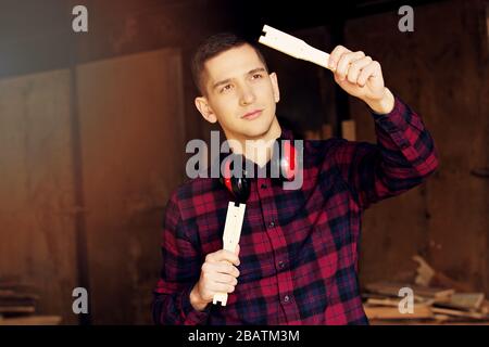 Workman at the sawmill. Young hardworking man Stock Photo