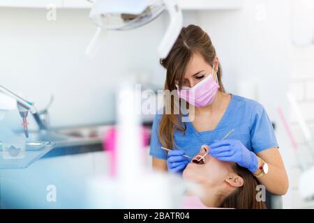 Dentist and patient in dentist office Stock Photo