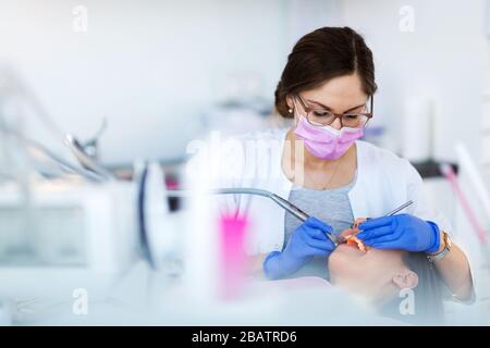 Dentist and patient in dentist office Stock Photo