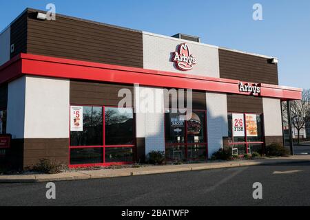 A logo sign outside of a Arby's restaurant location in Bel Air, Maryland on March 26, 2020. Stock Photo