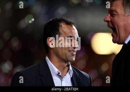 Wigan Athletic's manager Roberto Martinez and West Ham United manager Sam Allardyce joke on the touchline before the match Stock Photo
