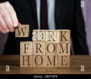 A safety message from a businessman to all workers to follow guidlines and work from home during the Coronavirus outbreak Stock Photo