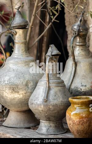 Old copper jugs in antique shop close up Stock Photo