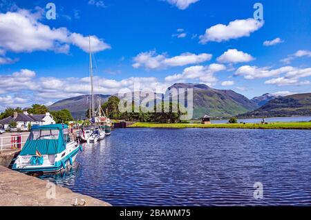 Vessels tied up in the Caledonian Canal basin at Corpach near Fort William Highland Scotland with mountain Ben Nevis in the background Stock Photo