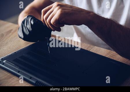 Technician installing new RAM module into the memory slot Stock Photo