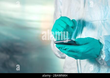 Epidemiologist using smartphone in Wuhan coronavirus quarantine, conceptual image with selective focus Stock Photo