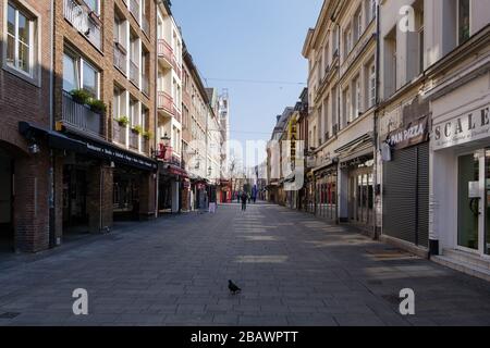 Empty street with closing shop, cafe and restaurant during quarantine from contagion of COVID-19 on walking street and plaza in old town in Düsseldorf Stock Photo