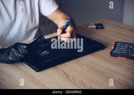 Technician installing new RAM module into the memory slot Stock Photo ...