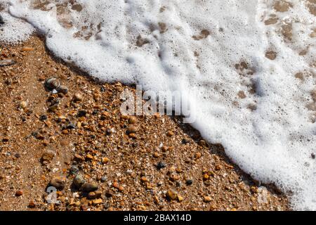 Waves lapping the pebbles on Brighton beach, England, United Kingdom Stock Photo