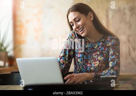 Young woman with laptop in cafe Stock Photo