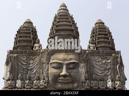 Buddha Statue Face and Ancient Khmer Architecture at Entrance Gate to Sangke Pagoda Budhhist Temple in Battambang, Cambodia Stock Photo