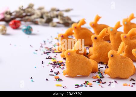 Easter gingerbread in the form of cute rabbits on sticks located on a white background, top view, the concept of the spring church holiday Stock Photo