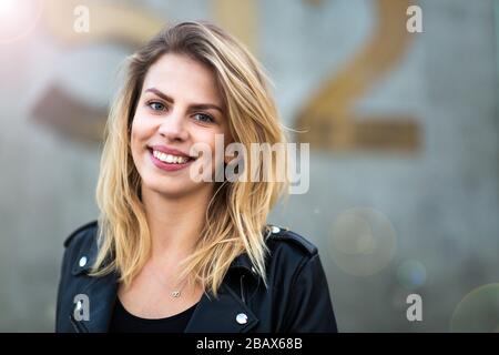 Portrait of a beautiful young woman at sunset Stock Photo