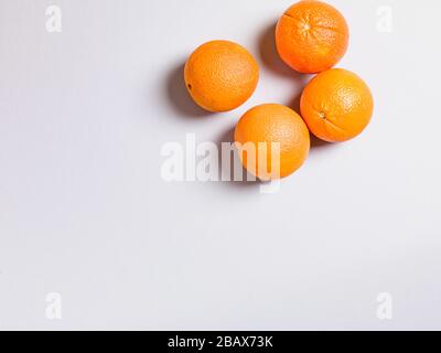 Three Fresh Oranges on Grey Background Stock Photo