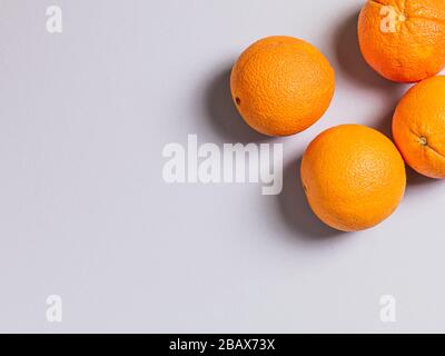 Three Fresh Oranges on Grey Background Stock Photo