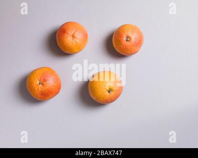 Three Fresh Oranges on Grey Background Stock Photo