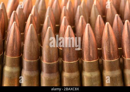 Lot of AK-47 Kalsnjikov rifle 7.62x39 caliber bullets in a row, close up view Stock Photo
