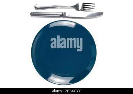 Blue empty plate with fork and knife isolated on white background Stock Photo