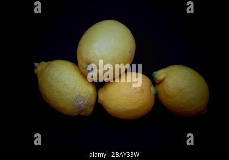 detail of a set of lemons on a dark background Stock Photo