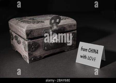 Next to a traditional Chinese box, a presentation card on which is written: from China with love. Writing can be removed as needed (copy space). Stock Photo