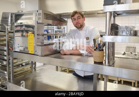 Cottbus, Germany. 25th Mar, 2020. Tim Sillack, chef and owner of the renovated Cavalierhaus in the Fürst-Pückler-Park Branitz, is standing in his kitchen. For the planned opening on April 1, he and his kitchen team spent a week cooking up and down the menu for a trial period. But the opening is cancelled for the time being due to the Corona pandemic. (to dpa "60 kilos of wild boar leg in the freezer: the Cavalierhaus is only sleeping") Credit: Patrick Pleul/dpa-Zentralbild/ZB/dpa/Ģ����ý Live News Stock Photo