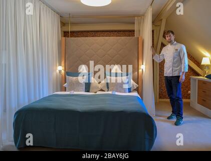 Cottbus, Germany. 25th Mar, 2020. Tim Sillack, chef and owner of the renovated Cavalierhaus in the Fürst-Pückler-Park Branitz, is standing in a hotel room. For the planned opening on April 1, he and his kitchen team spent a week cooking up and down the menu for a trial period. But the opening is cancelled for the time being due to the Corona pandemic. (to dpa "60 kilos of wild boar leg in the freezer: the Cavalierhaus is only sleeping") Credit: Patrick Pleul/dpa-Zentralbild/ZB/dpa/Ģ����ý Live News Stock Photo