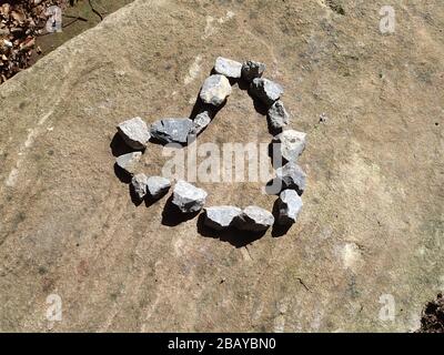 Small stones arranged into a heart shape on top of rock slab Stock Photo -  Alamy