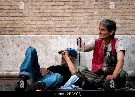 Closeup of two homeless men in Piazza de Santa Maria in Trastevere on a summer afternoon, Rome, Lazio, Italy, Europe, color Stock Photo