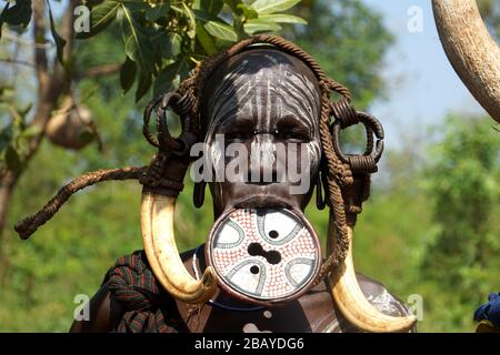 Portrait of Mursi Tribe Woman with Lip Plate and Cow Horn Decoration Stock Photo