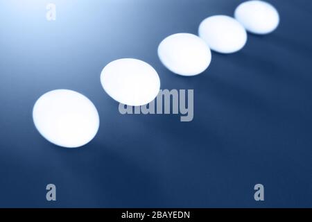 Five easter white eggs on blue background. Easter concept. Stock Photo