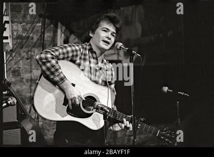 Folk singer John Prine singing on stage, Chicago, IL. 1971. Image from 35mm negative. Stock Photo