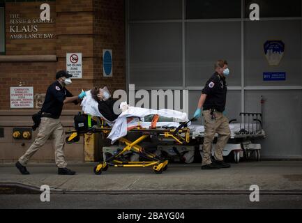Beijing, USA. 28th Mar, 2020. A patient is transferred to Maimonides Medical Center in Brooklyn of New York, the United States, March 28, 2020. The number of COVID-19 cases in the United States has topped 140,000, according to the latest tally from Johns Hopkins University's Center for Systems Science and Engineering (CSSE). Credit: Michael Nagle/Xinhua/Alamy Live News Stock Photo