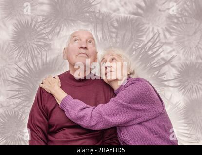 Coronavirus CoVid-19 Couple old aged senior people at home with illness disease sit down together forever Stock Photo