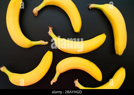 Background of yellow bananas on a black background. Stock Photo