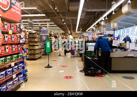 Vancouver, Canada - Mar 28,2020: Supermarket 'Safeway' is limiting the number of customers in the store and advising them to keep social distances Stock Photo