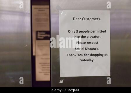 Vancouver, Canada - March 28, 2020: View of sign on the elevator doors 'Only 3 people permitted into the elevator' at the supermarket in Vancouver Stock Photo