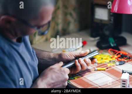 man hands repair make broken tv remote Stock Photo