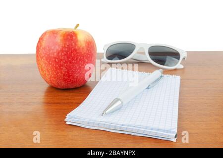 Apple glasses handle notepad lie on the table. Stock Photo