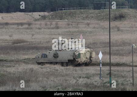 An M2A2 Bradley Infantry Fighting Vehicle assigned to 3rd Battalion, 67th Armored Regiment, 2nd Armored Brigade Combat Team, 3rd Infantry Division, utilizes the BGM-7 TOW anti-tank missile in support of Defender-Europe 20 during a table III Gunnery exercise at Drowsko Pomorskie Training Area, Poland, March 23. Table III Gunnery allows armored vehicle crews to exercise the fundamentals of scanning and maneuvering to maintain proficiency engaging targets in order to improve unit readiness. (U.S. Army photo by Sgt. Andres Chandler) Stock Photo