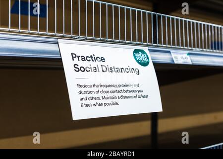 Mar 23, 2020 Santa Clara / CA / USA - Sign posted in a Supermarket requesting customers to Practice Social Distancing in order to prevent spread of CO Stock Photo