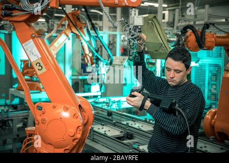 control the robotic arm using the remote control Stock Photo - Alamy