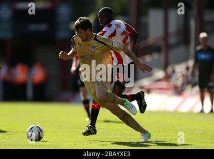Colchester United's Anthony Wordsworth (left) and Brentford's Toumani Diagouraga battle for the ball Stock Photo
