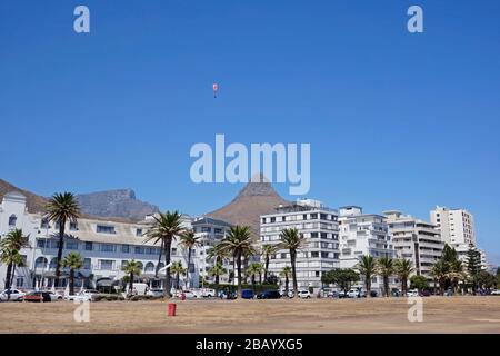 Para-gliders coming to land at Seapoint promenade after taking off from Lion's Head, Cape Town, South Africa. Stock Photo