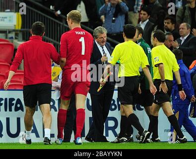 England manager Roy Hodgson (centre) speaks with match referee Cuneyt Cakir (right) after the final whistle. Stock Photo